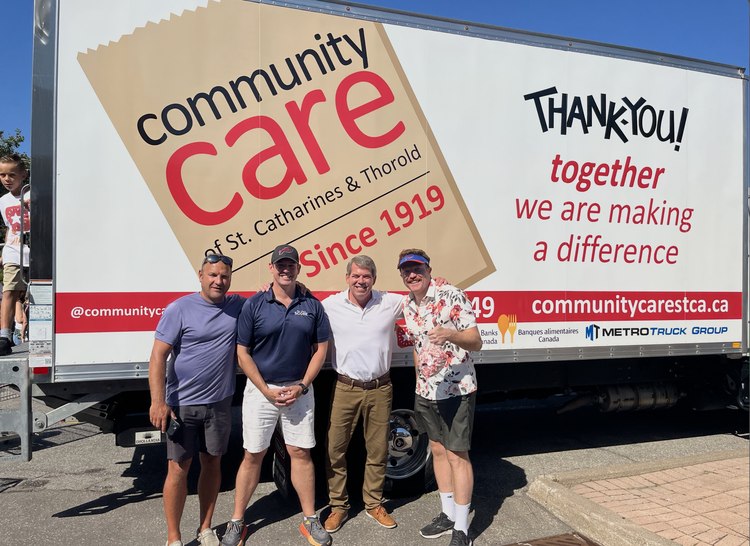 Matt Harris with three others in front of the Community Care of St. Catharines & Thorold truck at the Labour Day parade food drive