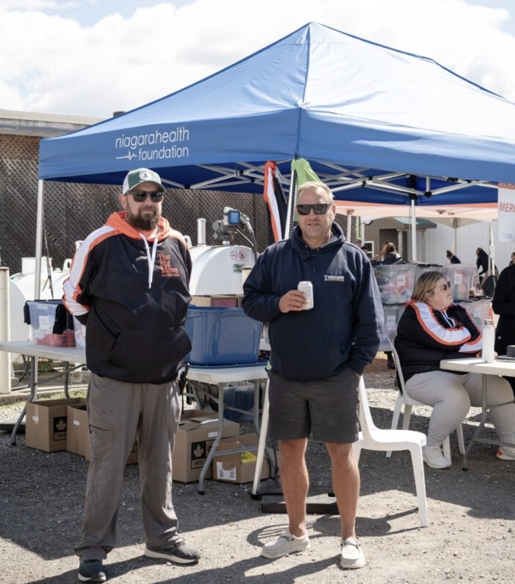 Two volunteers at the Niagara Health Foundation tent at the Big Move Cancer Ride